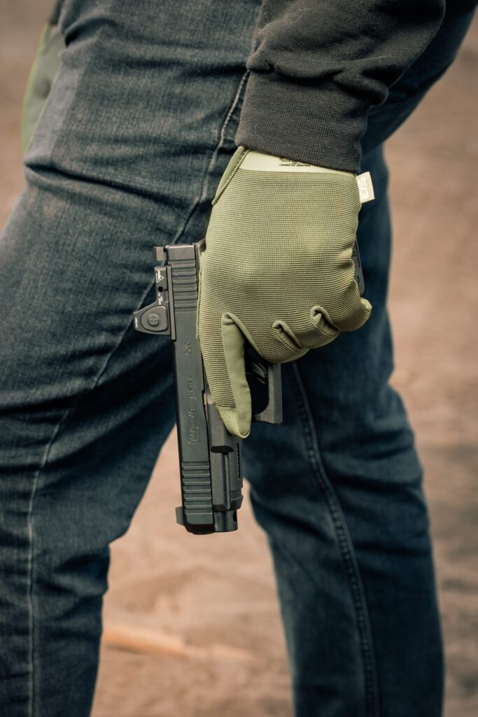 Man holding pistol. Photo by Trijicon