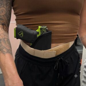 Person wearing a Sticky holster around waist, inside the waistband