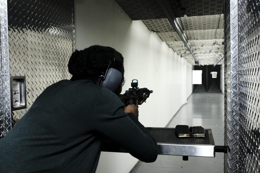 man in indoor range shooting