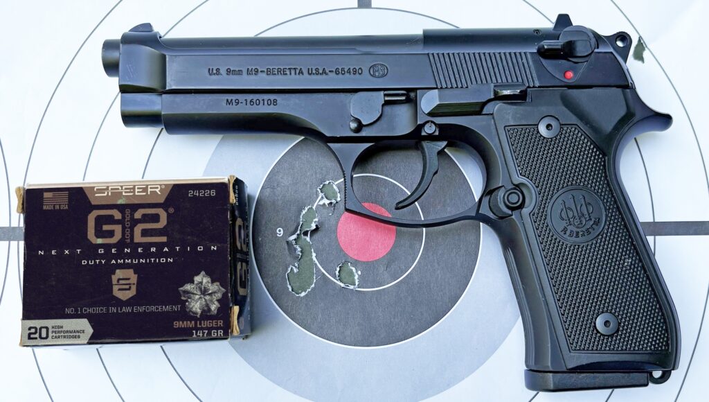 pistol laying on target with ammunition