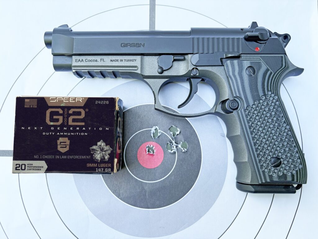 Pistol lying on target with ammunition