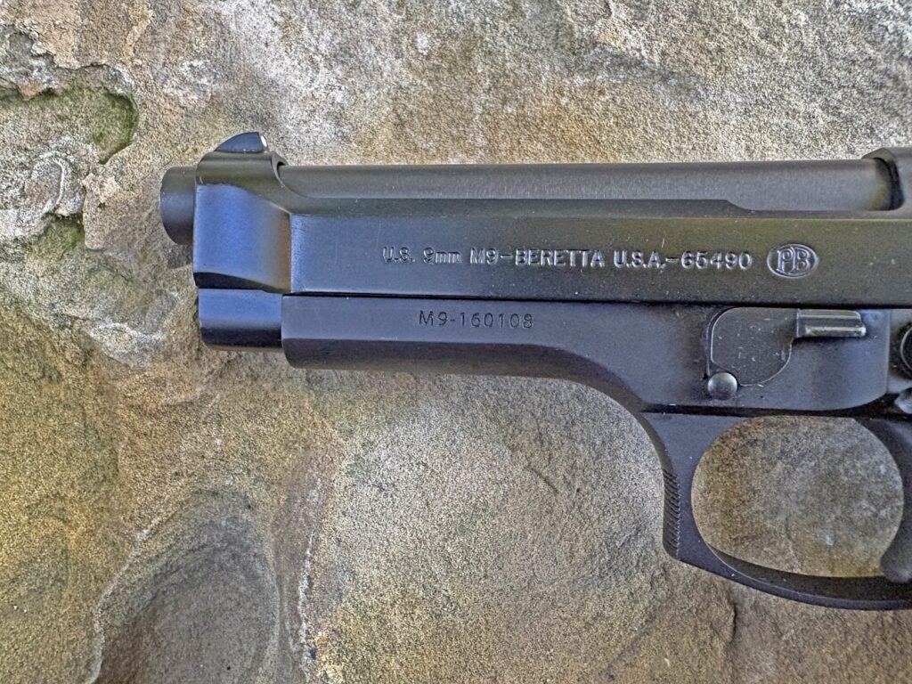 closeup of pistol slide with stamped lettering