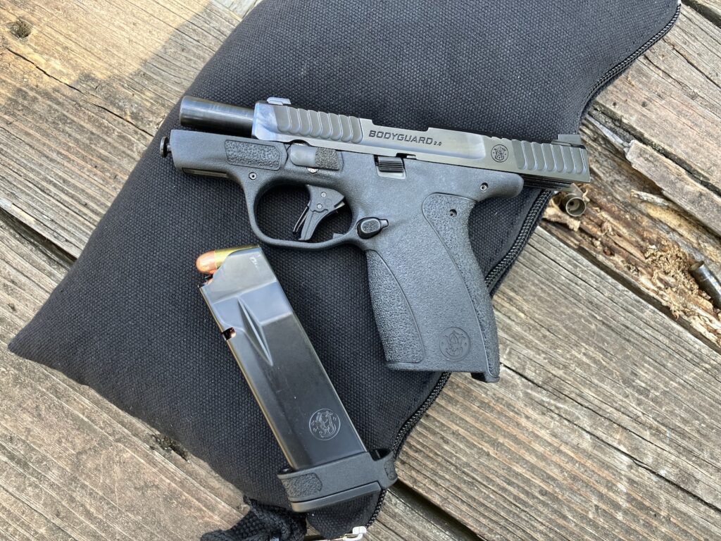 Pistol slide back with magazine on shooting bench