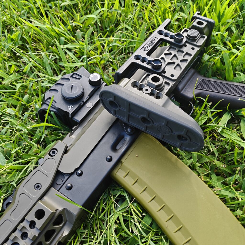 rifle on grass with folding stock