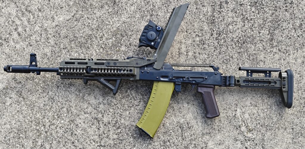 top of rifle open on concrete