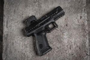 optic on pistol resting on concrete