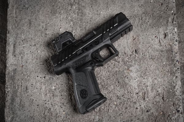 optic on pistol resting on concrete
