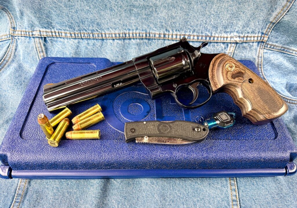 Rifle with ammo and knife on mat