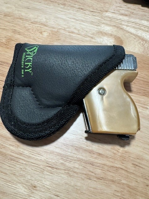 Lorcin pictured in a sticky holster for pocket carry